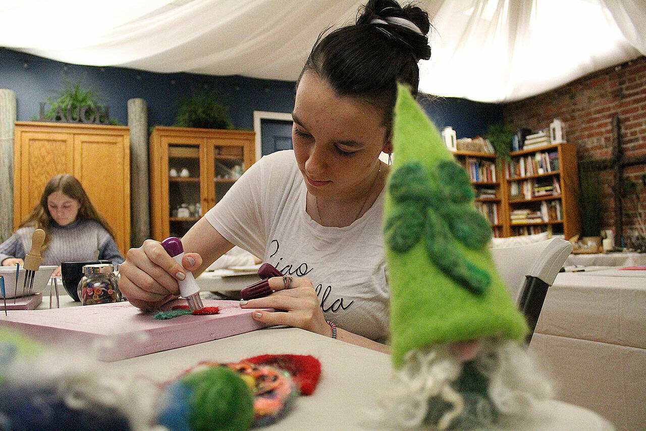 Enumclaw’s Urban Sanctuary on Myrtle Avenue is hosting mixed-media art sessions through March 12. Pictured is Emily Gunnells making a felt cherry. Photos by Ray Miller-Still