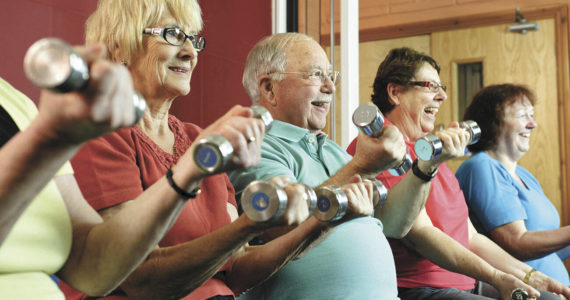 Lifting weights or using a resistance band for exercise is a great way for seniors to build strength. Image courtesy Metro Creative Connections