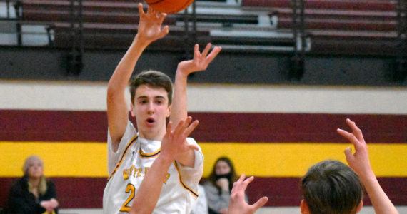 Pictured is Hornets' Carson Voellger sending a pass to teammate Rylan Donovan (11) during the home-court, 74-62 win game against Bremerton on Feb. 16. File photo by Kevin Hanson