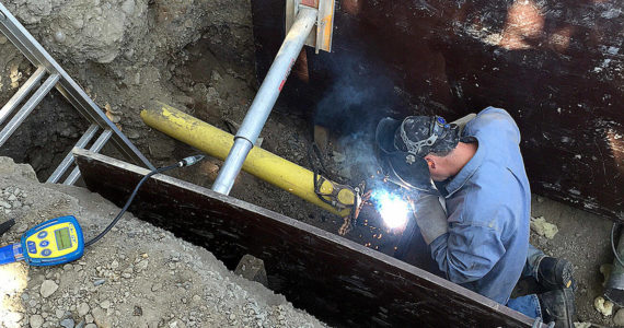 Enumclaw welder Nick Burden improving the gas line underneath Warner Avenue. Photo courtesy the city of Enumclaw