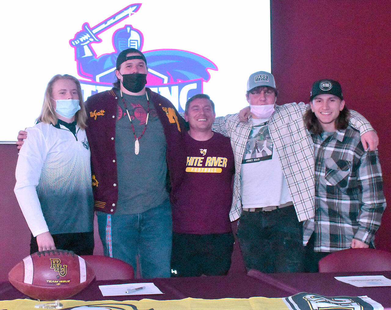 During a ceremony at White River High, a quartet of Hornet seniors signed letters sealing their agreement to play college ball before gathering for a photo with their coach, Kenny Pirone. From left are Cole Cashman, Wyatt Davis, Pirone, Ryan Stapleton and Payne Plaster. Photo by Kevin Hanson