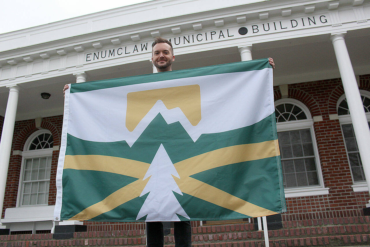 Kyle Miller, one of more than 50 people who entered Enumclaws design-a-flag contest last year, had his design chosen to represent the city. Photo by Ray Miller-Still