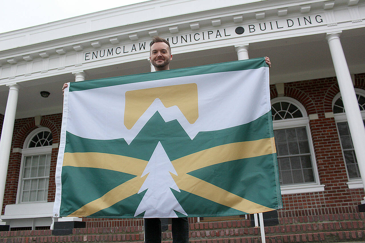 Kyle Miller, one of more than 50 people who entered Enumclaw’s design-a-flag contest last year, had his design chosen to represent the city. Photo by Ray Miller-Still