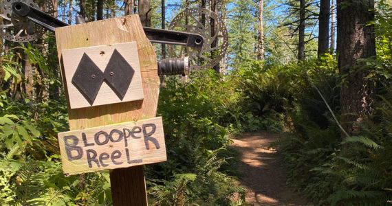Signs along the "east side" of the Black Diamond Open Space indicate its favored status among mountain bikers. On the "west side" the ladder bridge spans a peaceful stretch of Ravensdale Creek. Photo by Kevin Hanson