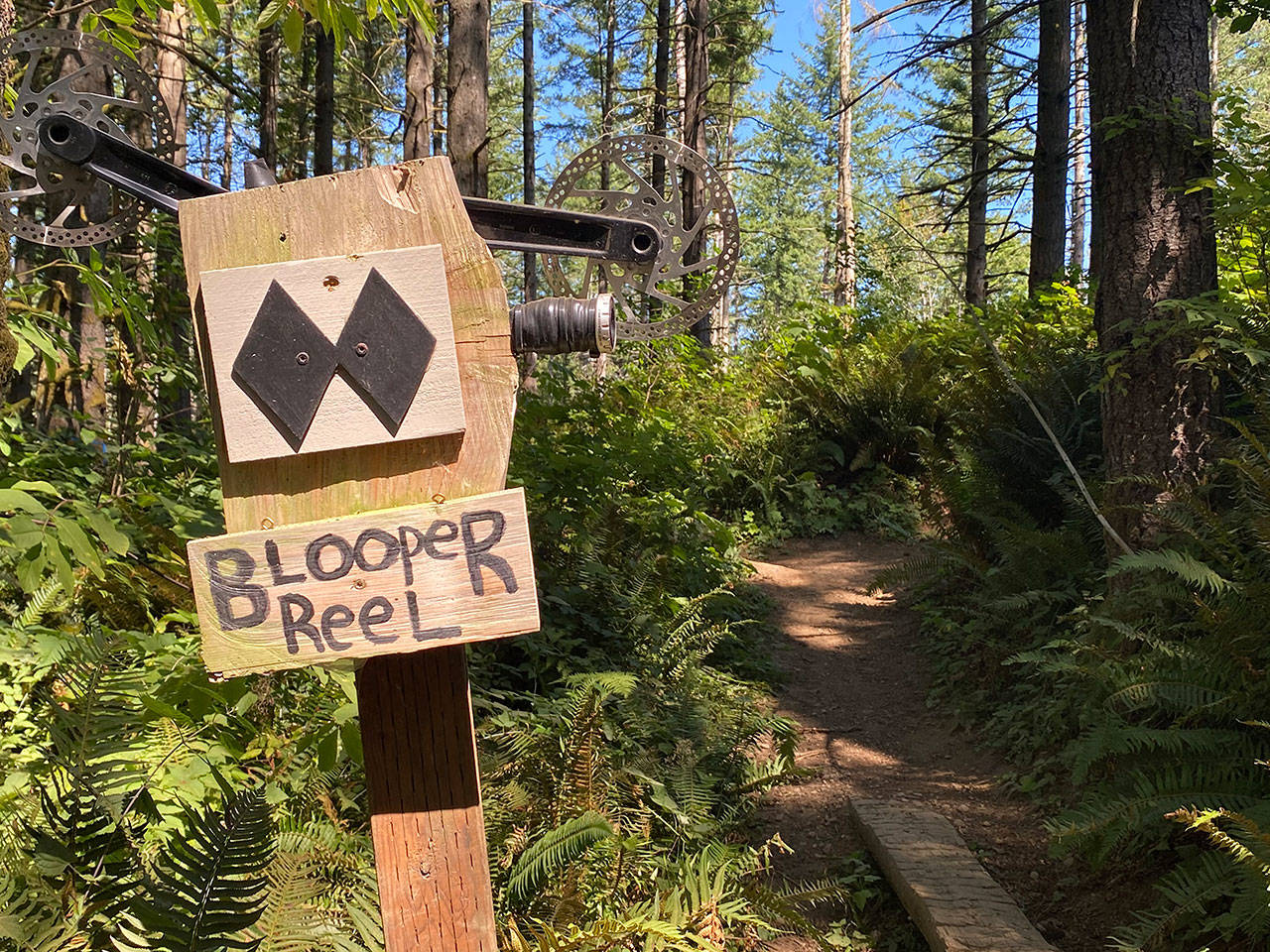 Signs along the “east side” of the Black Diamond Open Space indicate its favored status among mountain bikers. On the “west side” the ladder bridge spans a peaceful stretch of Ravensdale Creek. Photo by Kevin Hanson