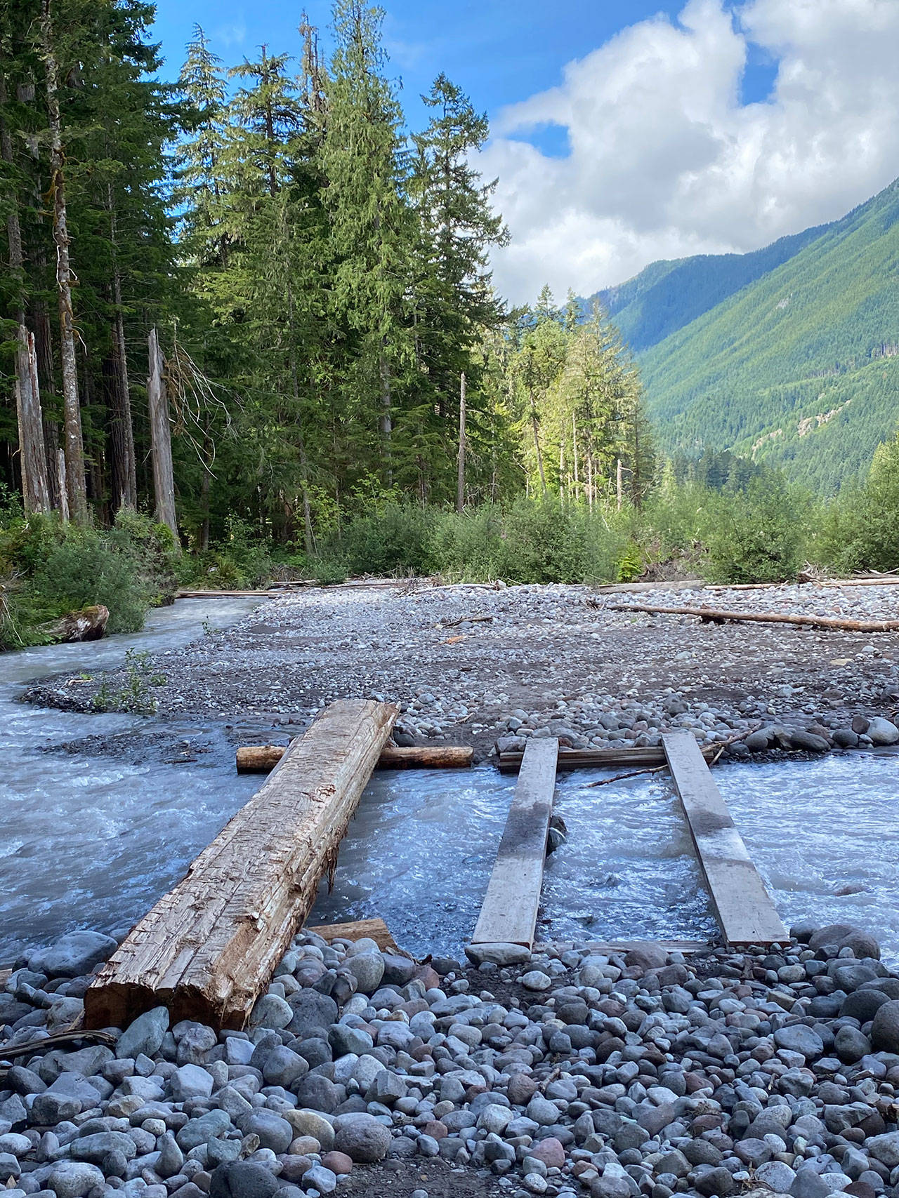 Be careful: getting across a fast-moving stretch of the Carbon River requires sure footing and a sense of balance. Photo by Kevin Hanson