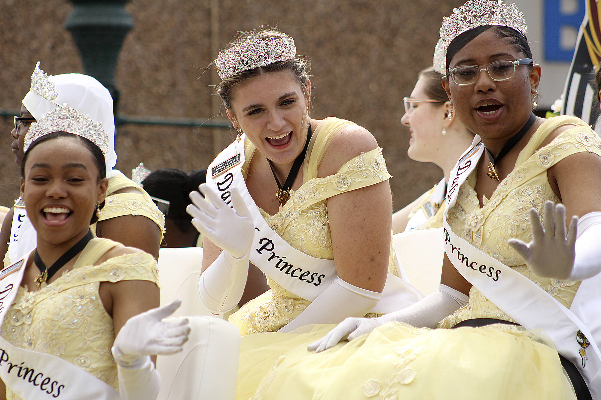 White River High School’s Princess Julia Schmidt, center, waves to crowds as the parade rolls through Sumner on April 9. Photo by Ray Miller-Still
