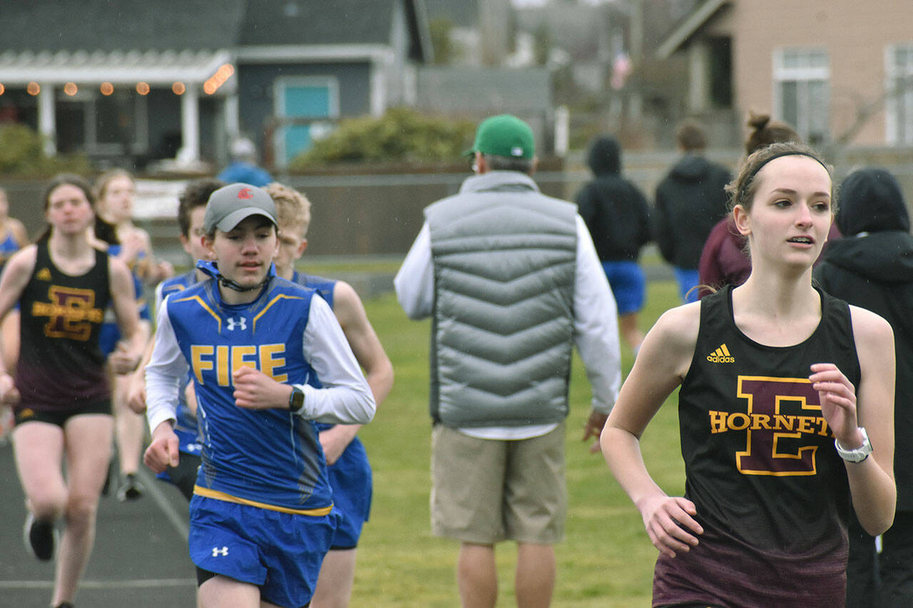Ava Sawyer, right, and Lindsay Essex, far left, posted first and second place showings, respectively, in the girl’s 1600 meter run during Enumclaw’s March 17, 2022 bout against Fife. File photo by Alex Bruell