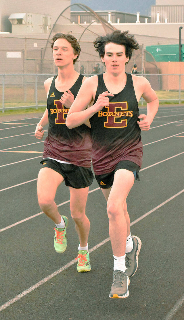 Enumclaw High’s Trevor Storm (left) and Evan Cheney ran a strong 800 meters during the Hornets’ home meet last week against Clover Park. In the end, Cheney won with a time of 2:11.8, just a stop ahead of Storm’s 2:12.0. Both were more than 10 seconds ahead of the third-place finisher, helping EHS to a league victory over the Warriors. Photo by Kevin Hanson
