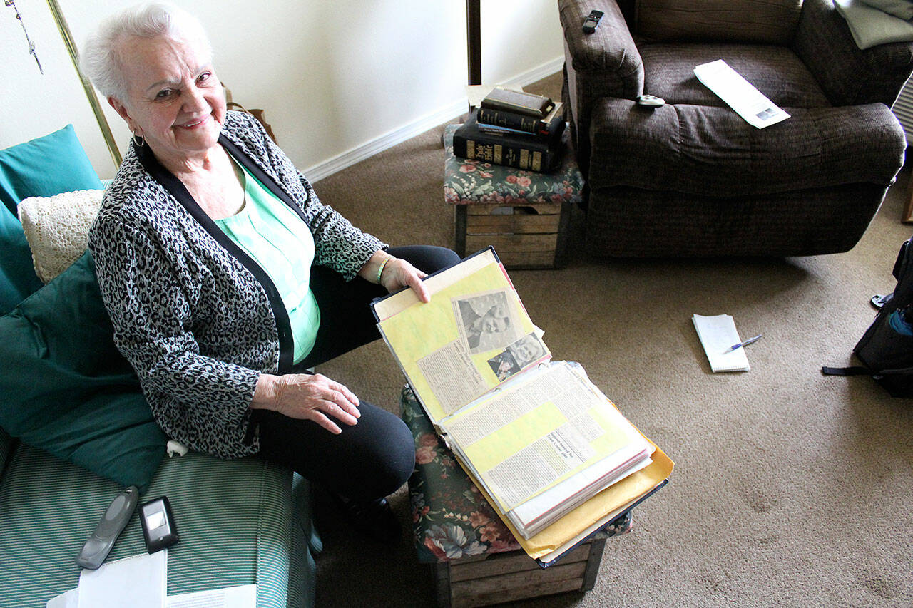 Dorothy Sleigh has kept a few things from her time with the Enumclaw Chamber of Commerce, including an entire scrapbook of news clippings, photos, and awards. Photo by Ray Miller-Still
