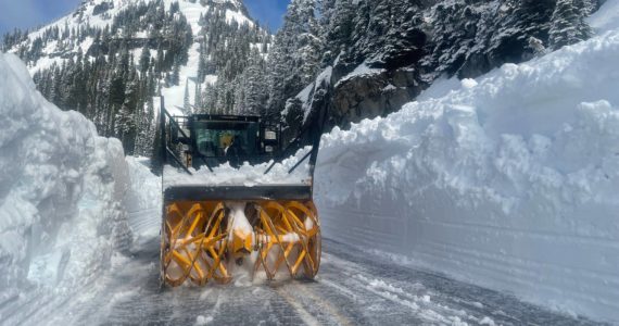 WSDOT shared this image of a snow blower fighting huge walls of snow on SR 410 Chinook Pass, which crews estimated on May 19 would remain closed for a few more weeks.