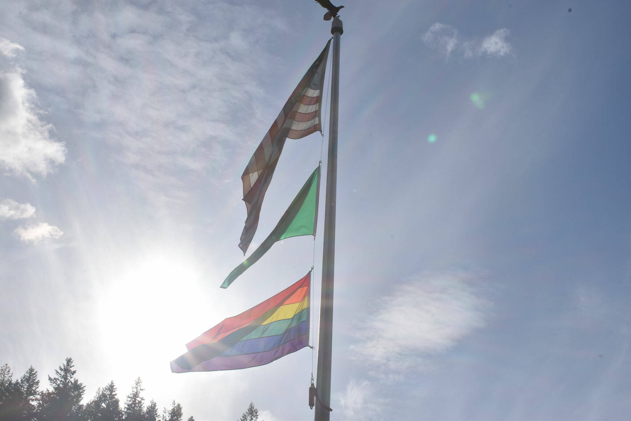 The flagpole outside Wilkeson Town Hall flies the American flag, the Washington State flag and the LGBT Pride flag on Wednesday June 8. Photo by Alex Bruell.
