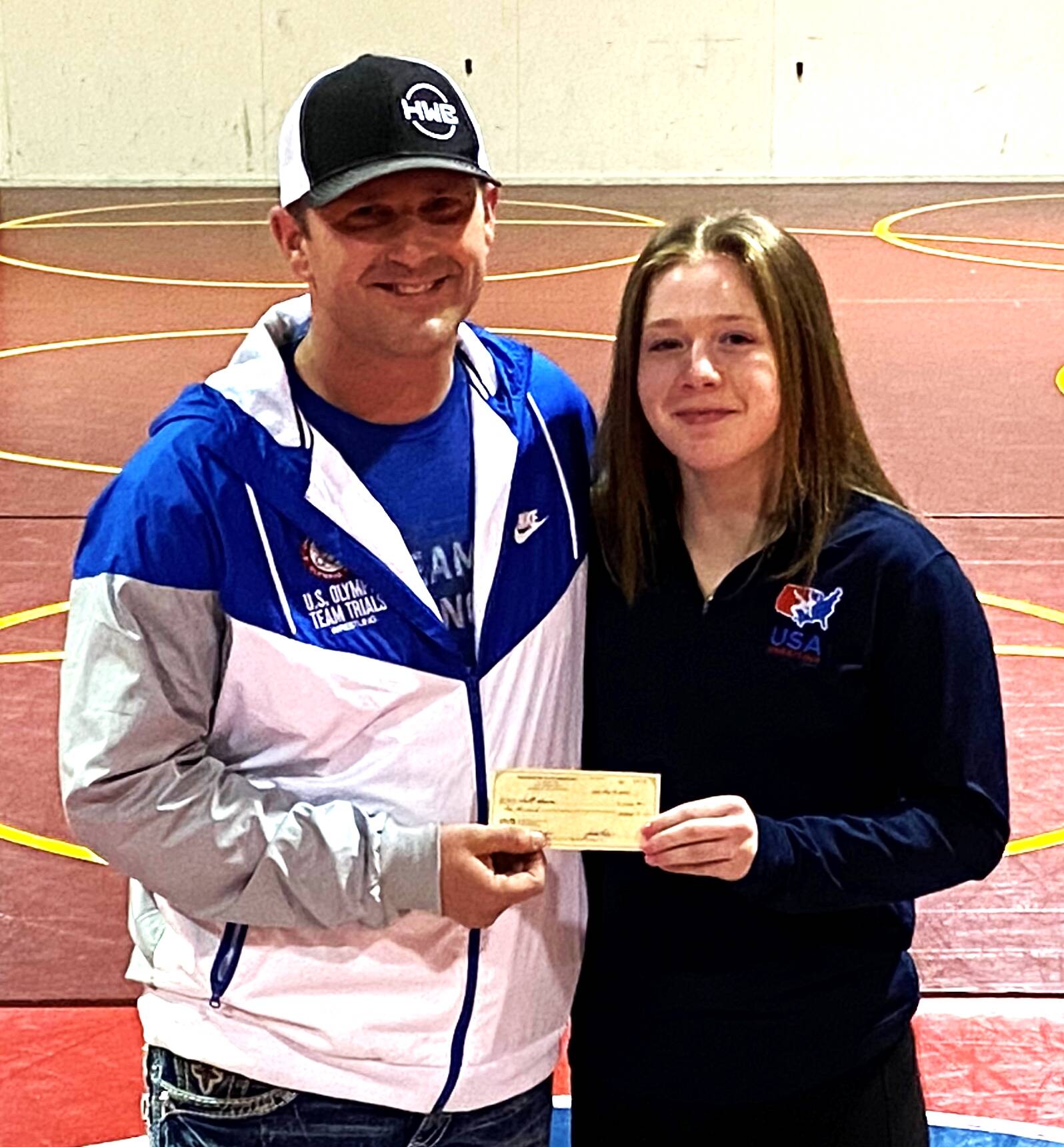 PHOTO BY ED HAWTHORNE
Justin Newby, president of the Washington State Wrestling Association, presented Shelby Moore with a $1,000 check during a ceremony in Buckley.
