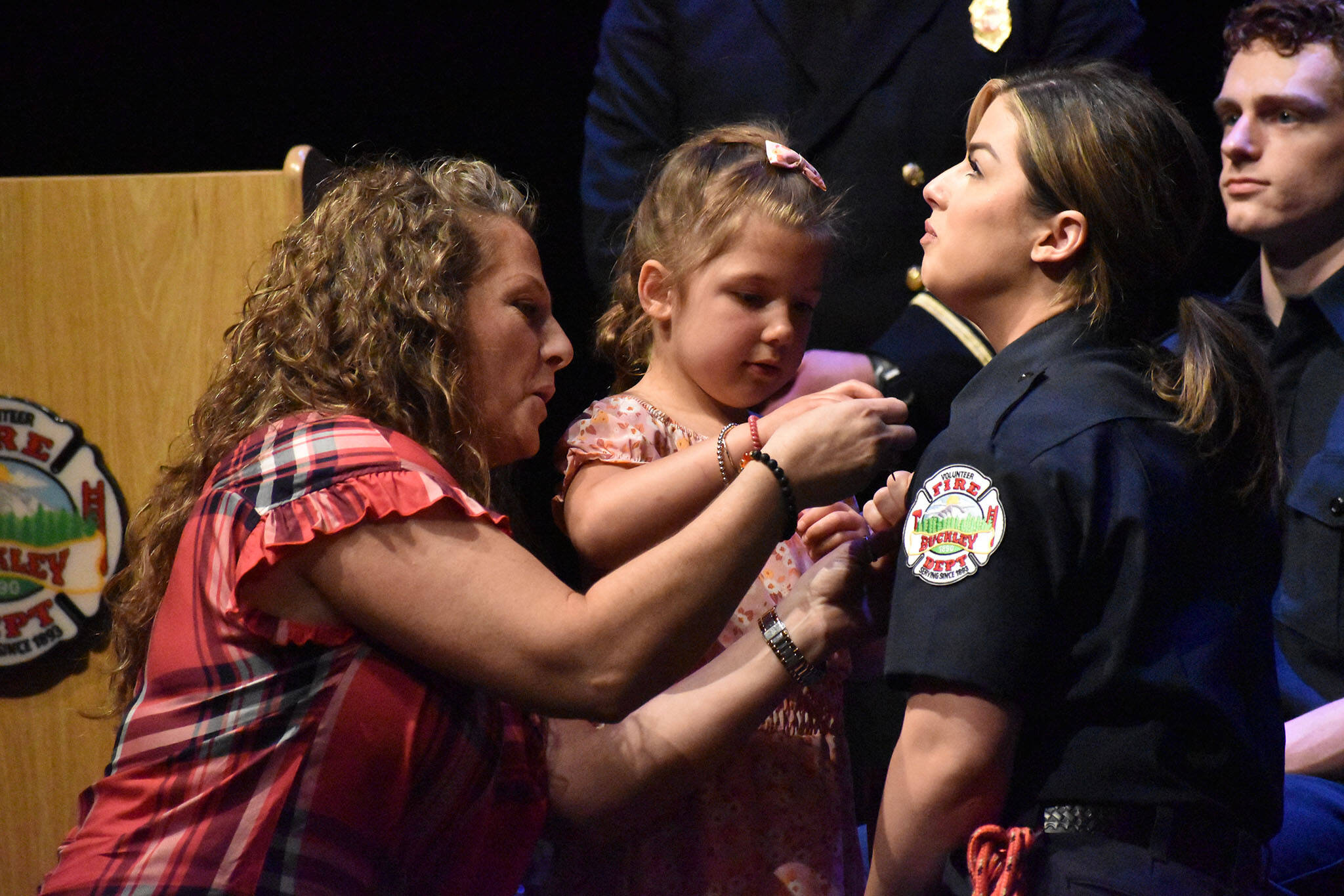 Graduating recruit Kelcie Gahley is pinned by her family during the ceremony.