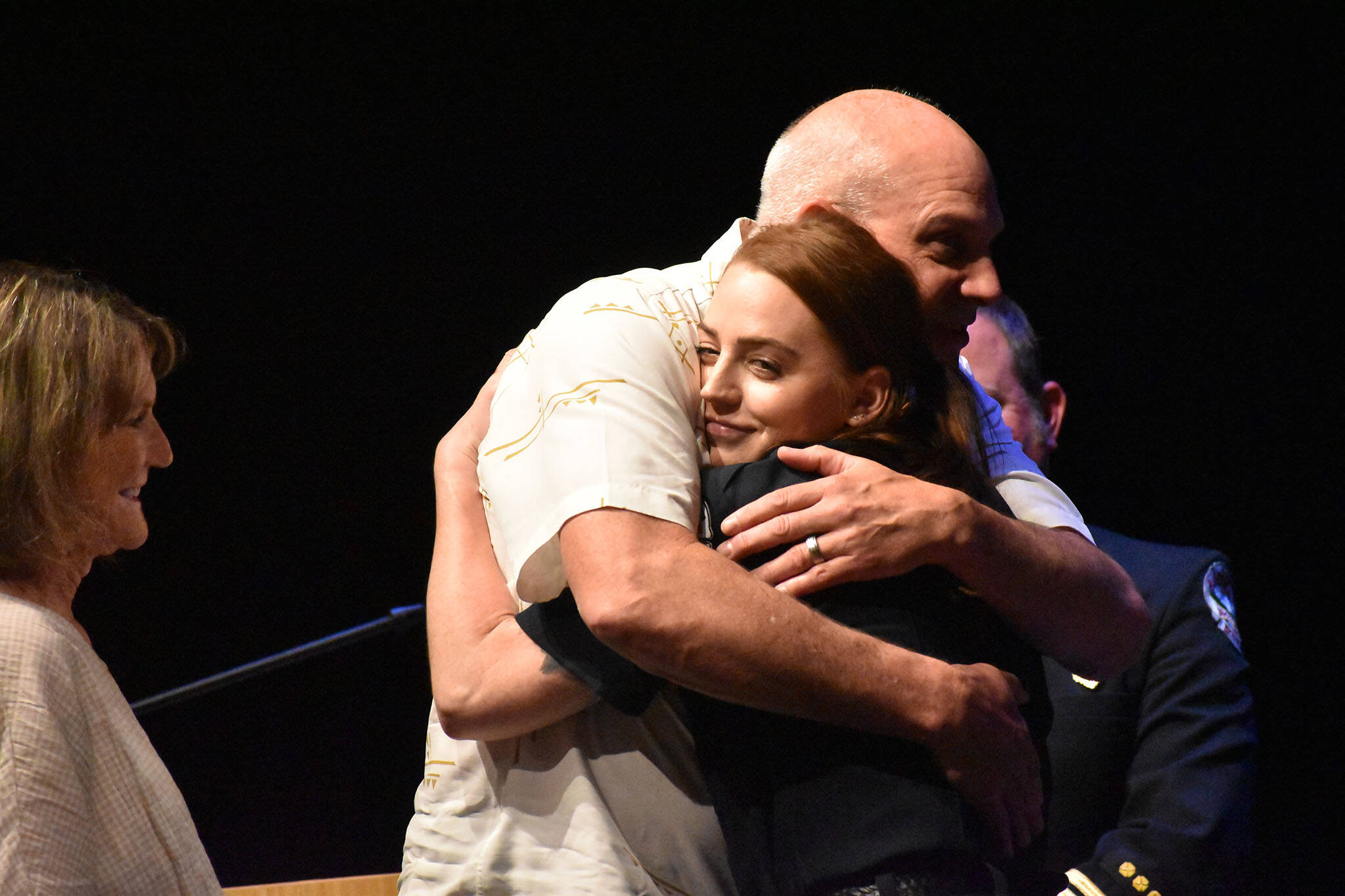 Graduating recruit Hannah Dahlquist shares a hug with her father during the badge pinning ceremony.