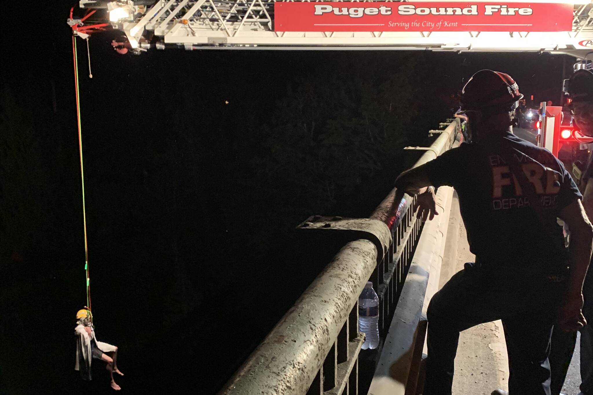 This photo, posted by a Public Information Officer, shows a Puget Sound Fire truck being used to rescue one of the people who became stranded in the Green River Sunday.