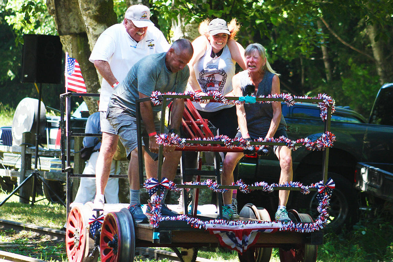 A group of racers gives it all they’ve got at the handcar races. Photo by Ray Miller-Still