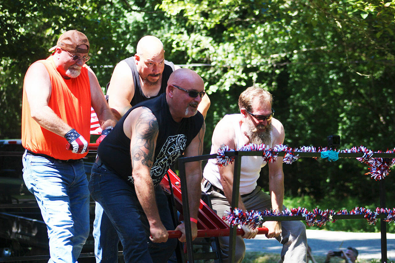 A team pushes their handcar down the track at the Wilkeson handcar races. Photo by Ray Miller-Still