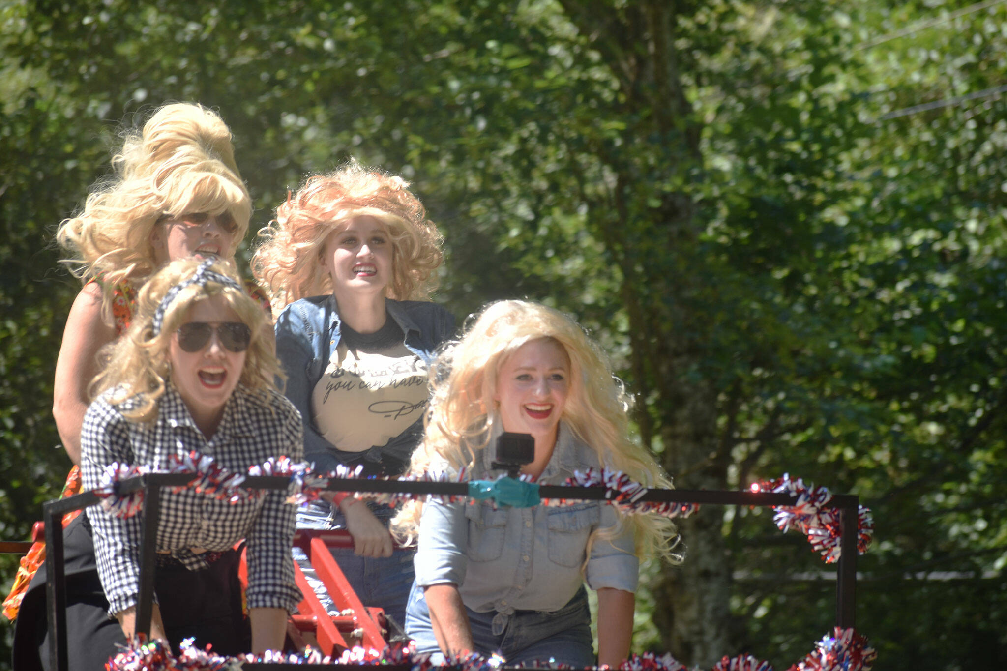 A Dolly Parton-inspired team races to the end of the track at the handcar races. Photo by Alex Bruell