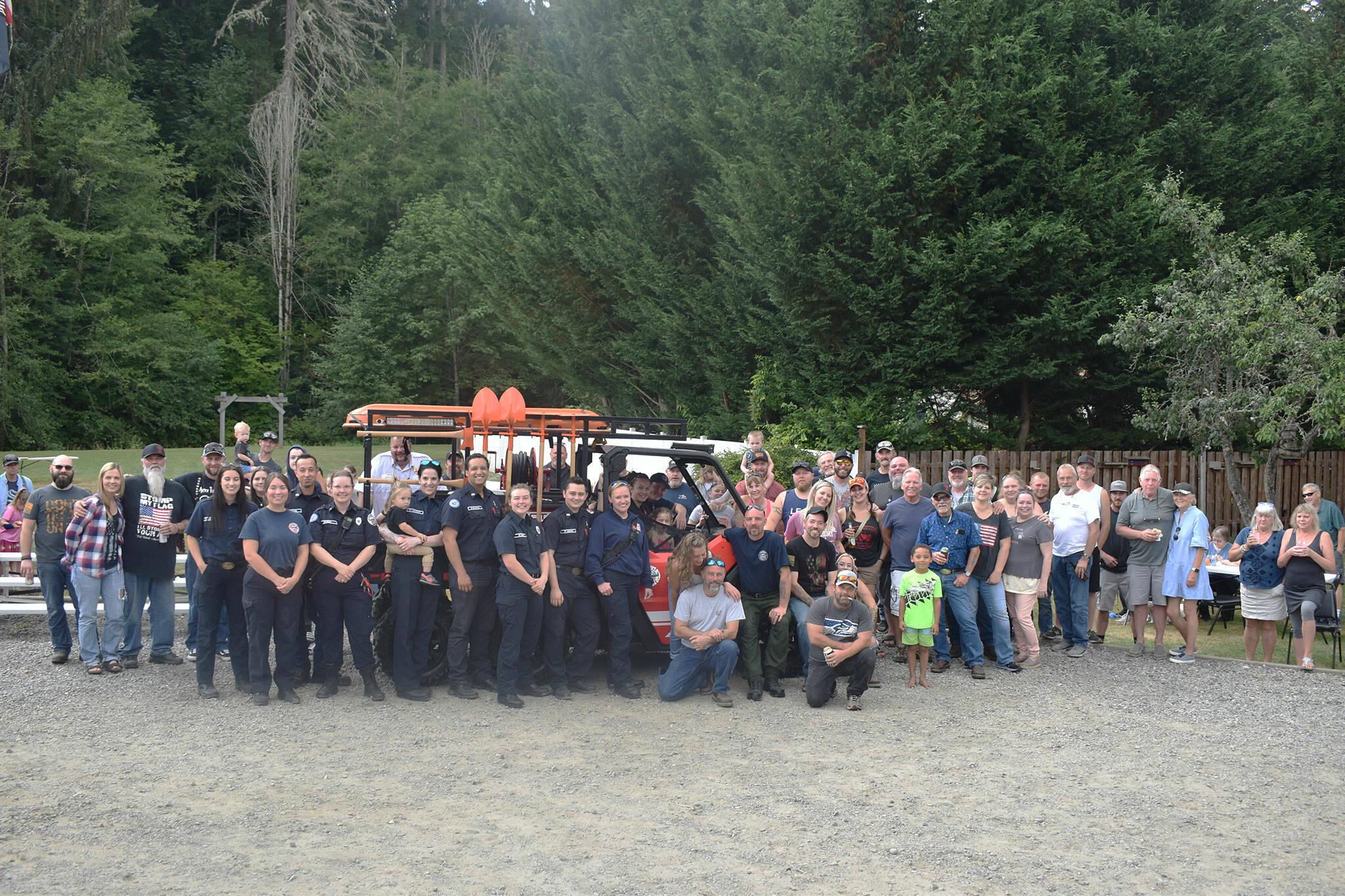 Members of the Buckley Fire Department and Wilkeson community pose for a group photo with the new side-by-side.