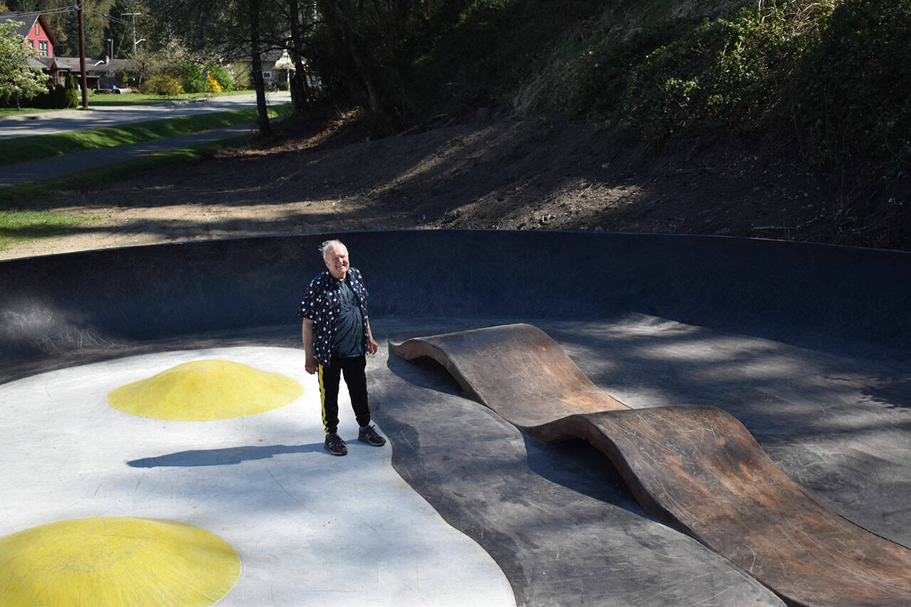 John Hillding stands in the center of the Bacon and Eggs skatepark, which he designed. The Wilkeson skatepark came about from a state grant, Grindline Skateparks, organizing by Hillding and city leaders, and a lot of volunteers. Photo by Alex Bruell.
