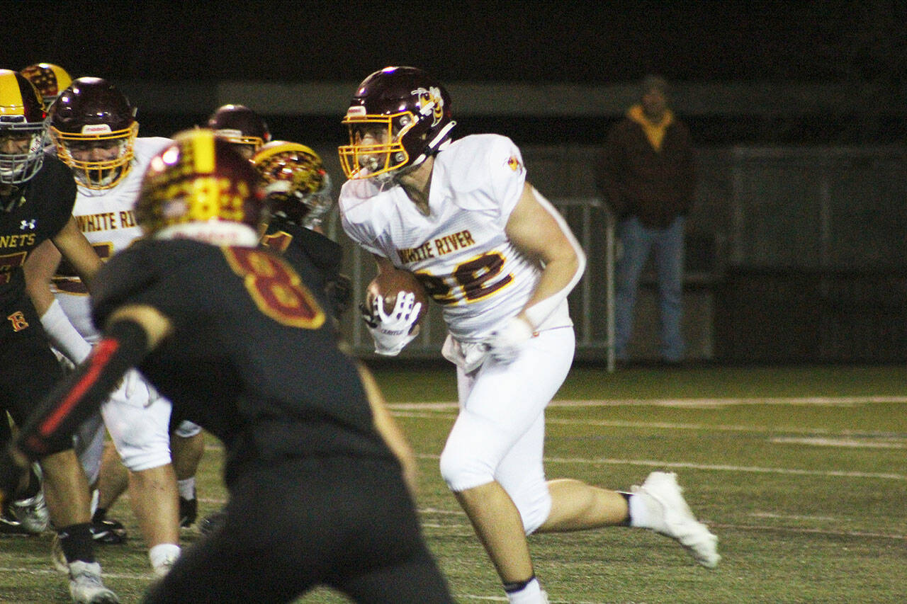 Jacob Rennaker, No. 22, had to fight to be this year’s starting QB against Aaden Rathbun; he’s pictured here at the 2021 Battle of the Bridge game against Enumclaw. Photo by Ray Miller-Still