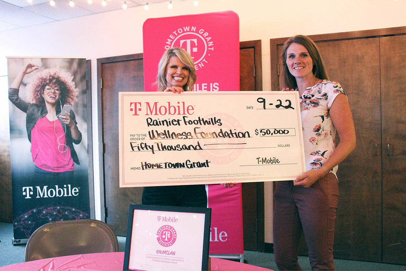 Debbie Hilliker, T-Mobile market manager for the Olymipa region, presenting the obligatory oversized check to Rainier Foothills Wellness Foundation Executive Director Sara Stratton during last Thursday’s Full Bellies event. Photo by Ray Miller-Still