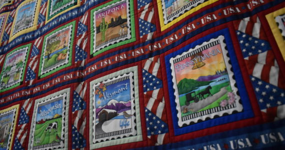 The Crystal Quilters of Enumclaw held their annual two-day quilt show last weekend at the Enumclaw Expo Center, showing off unique patterns, detailed stitchwork and quilts with decades of history. In these photos: Lisa Larkin's "A Marathoner's Story" quilt, containing postcard designs from each of the 50 states and several other landmarks, made by Lisa Larkin to commemorate her husband's marathons in each of those locations; Susanne Wick's Quilt of Valor for her husband Robert Wick, commemorating his service in the U.S. Navy with real patches; and "Planets," a piece purchased from a Wyoming store and quilted with glow-in-the-dark thread by owner Linda Bowman.
