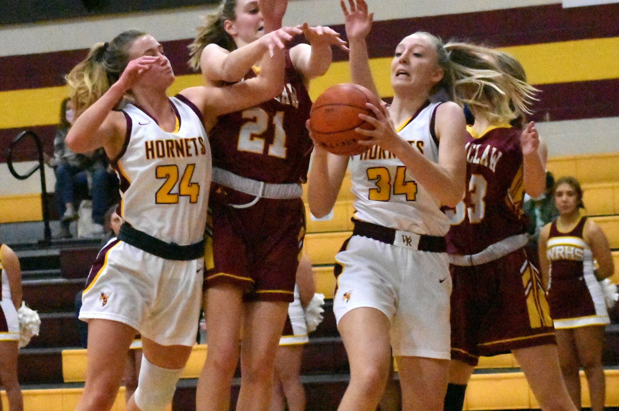 White River’s Vivian Kingston pulls down a rebound as she and teammate Josie Jacobs (24) crash the boards during a battle last season against Enumclaw.