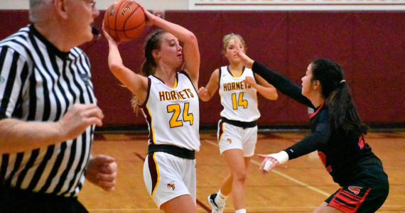 The White River girls rolled past Orting High Friday night, allowing the visiting Cardinals just eight points in each half on the way to a lopsided 68-16 victory. Pictured is Josie Jacobs (24) looking for an open teammate and Vivian Kingston (34) prepares to put up a shot under the basket. The victory pushed White River’s record to 3-0 on the season and 2-0 in South Puget Sound League 2A play. Photo by Kevin Hanson