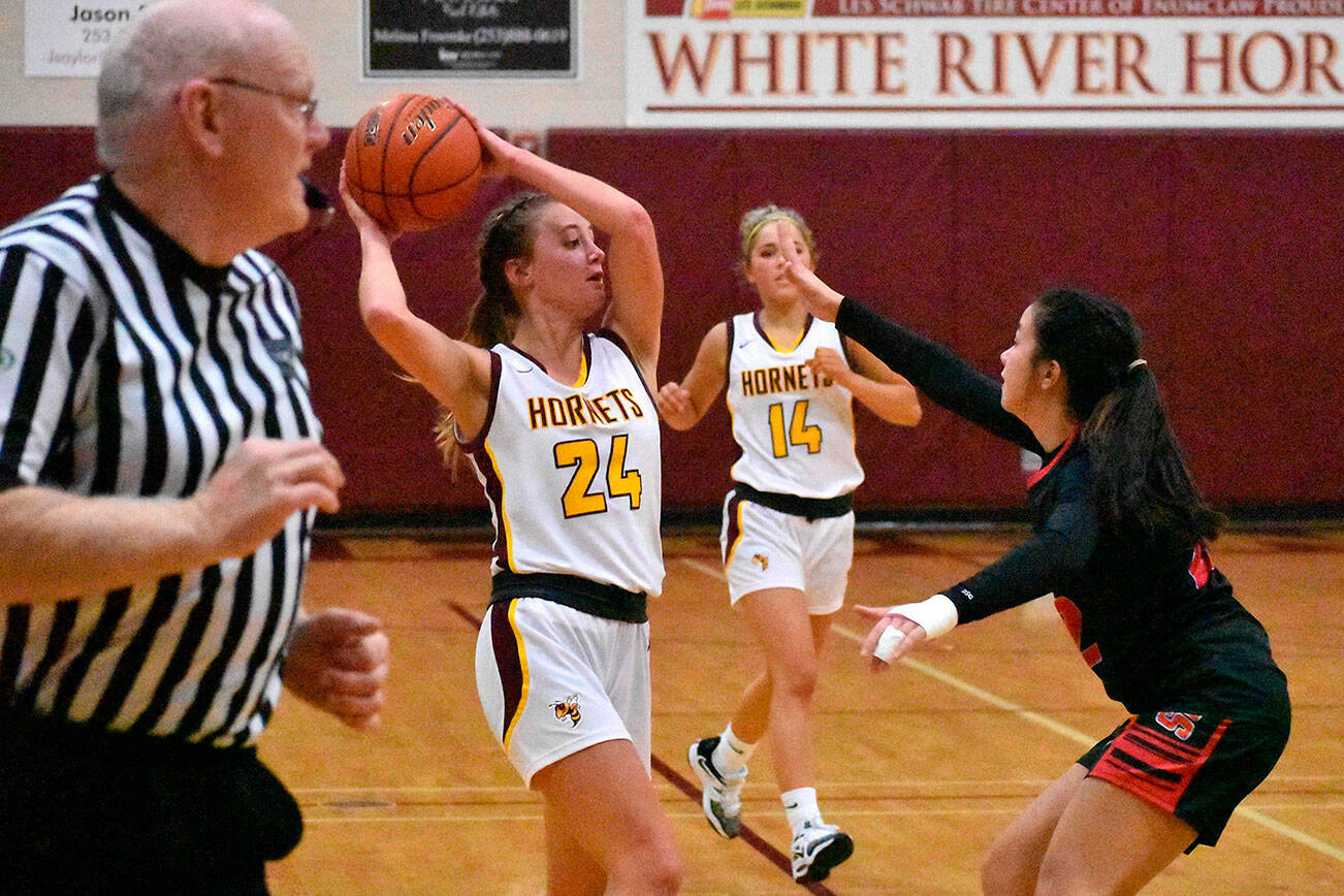 The White River girls rolled past Orting High Friday night, allowing the visiting Cardinals just eight points in each half on the way to a lopsided 68-16 victory. Pictured is Josie Jacobs (24) looking for an open teammate and Vivian Kingston (34) prepares to put up a shot under the basket. The victory pushed White Rivers record to 3-0 on the season and 2-0 in South Puget Sound League 2A play. Photo by Kevin Hanson