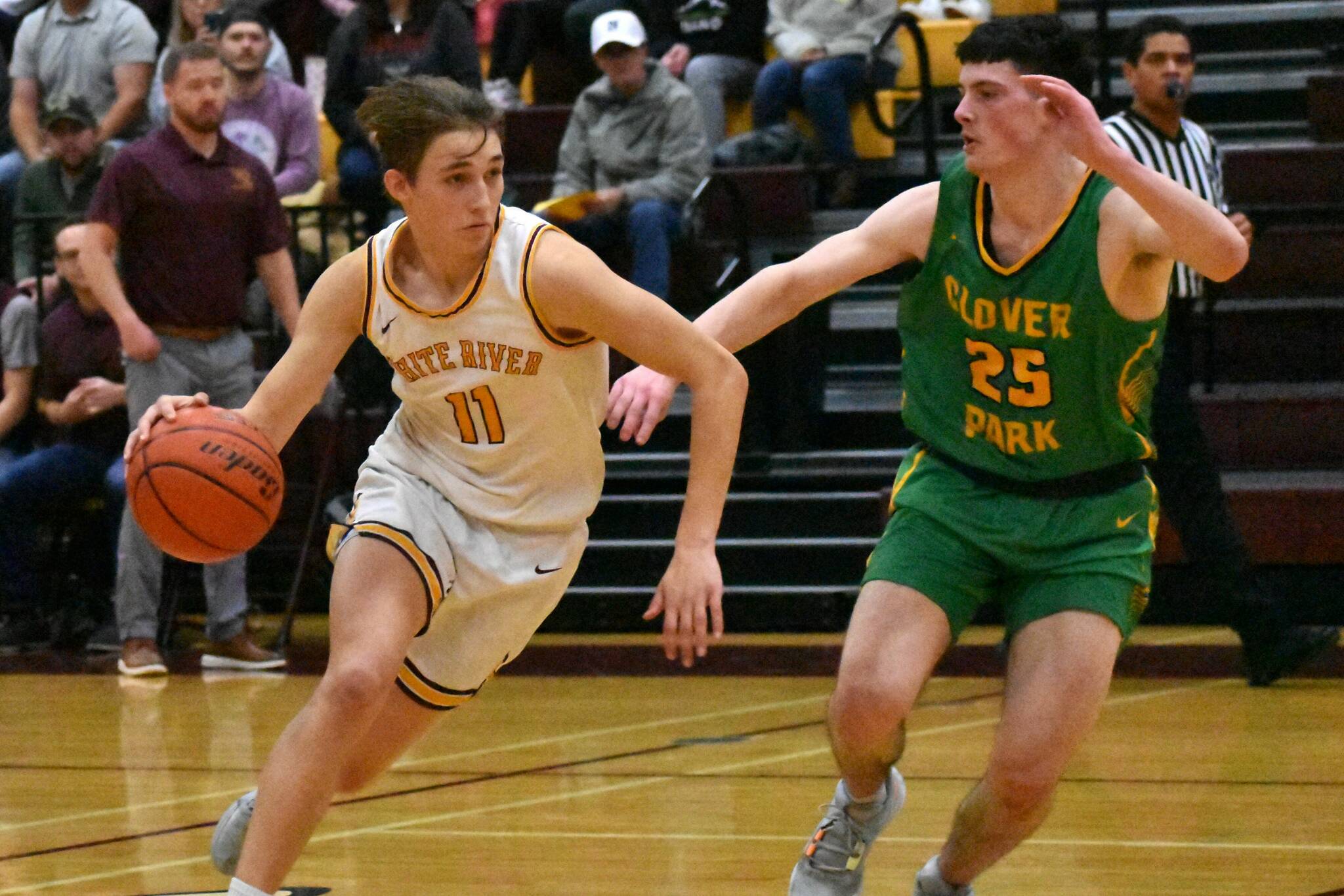 In the Buckley gym, junior Tyce Donovan (11) races past a Clover Park defender. Photo by Kevin Hanson
