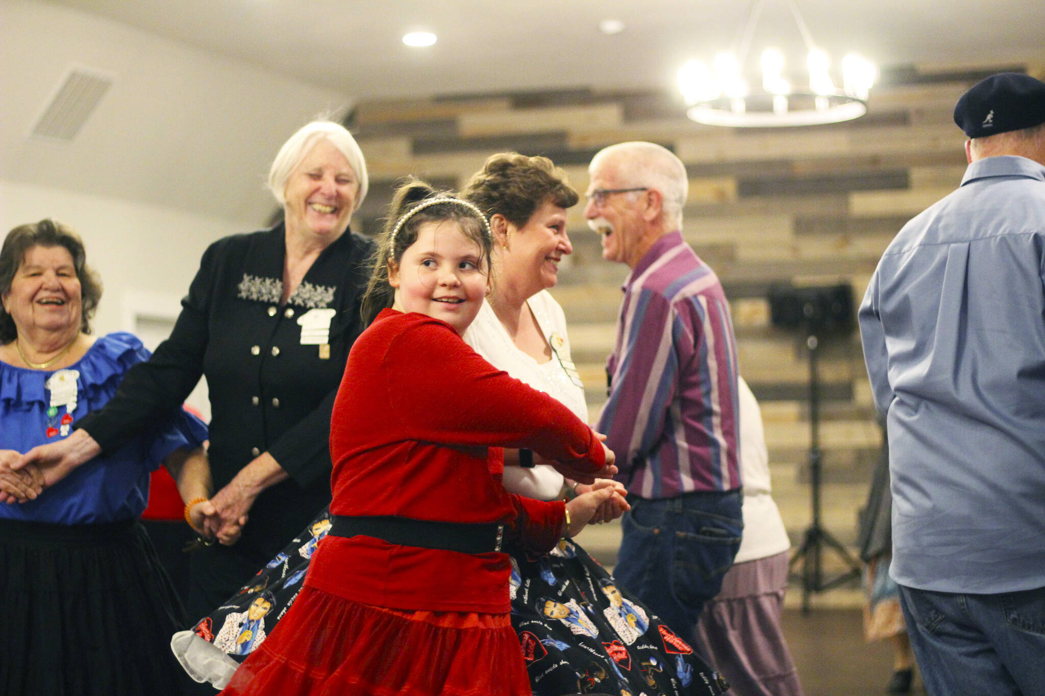 The Spinners meet every Friday night for an open dance. Many of the dances are square dances, but the club also has a few round dances as well. Pictured is Taylor Wild, the youngest member of the group, in red. Photo by Ray Miller-Still