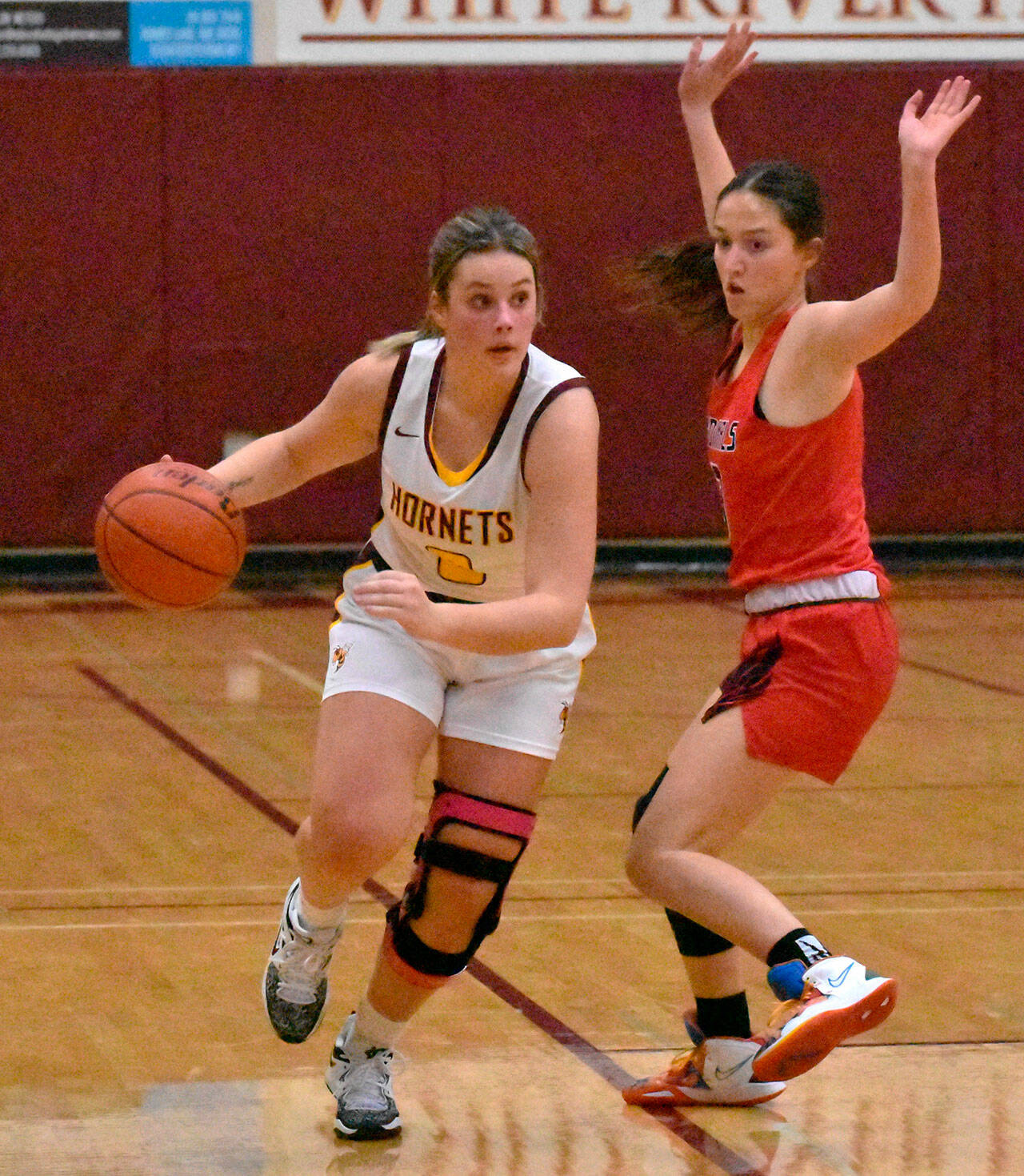 MacKenzie Hinson (3) pushes the ball upcourt and Ally Green (23) gets fouled during a drive to the hoop. Photo by Kevin Hanson