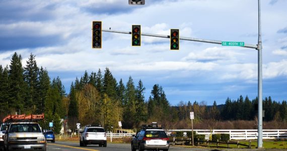 Drivers negotiate the Krain intersection without power Monday morning after a major windstorm knocked out power across much of the Plateau Jan. 9. In Enumclaw, tossed-around trash and recycling bins and downed branches signaled the effects of the angry winds. Photo by Alex Bruell.
