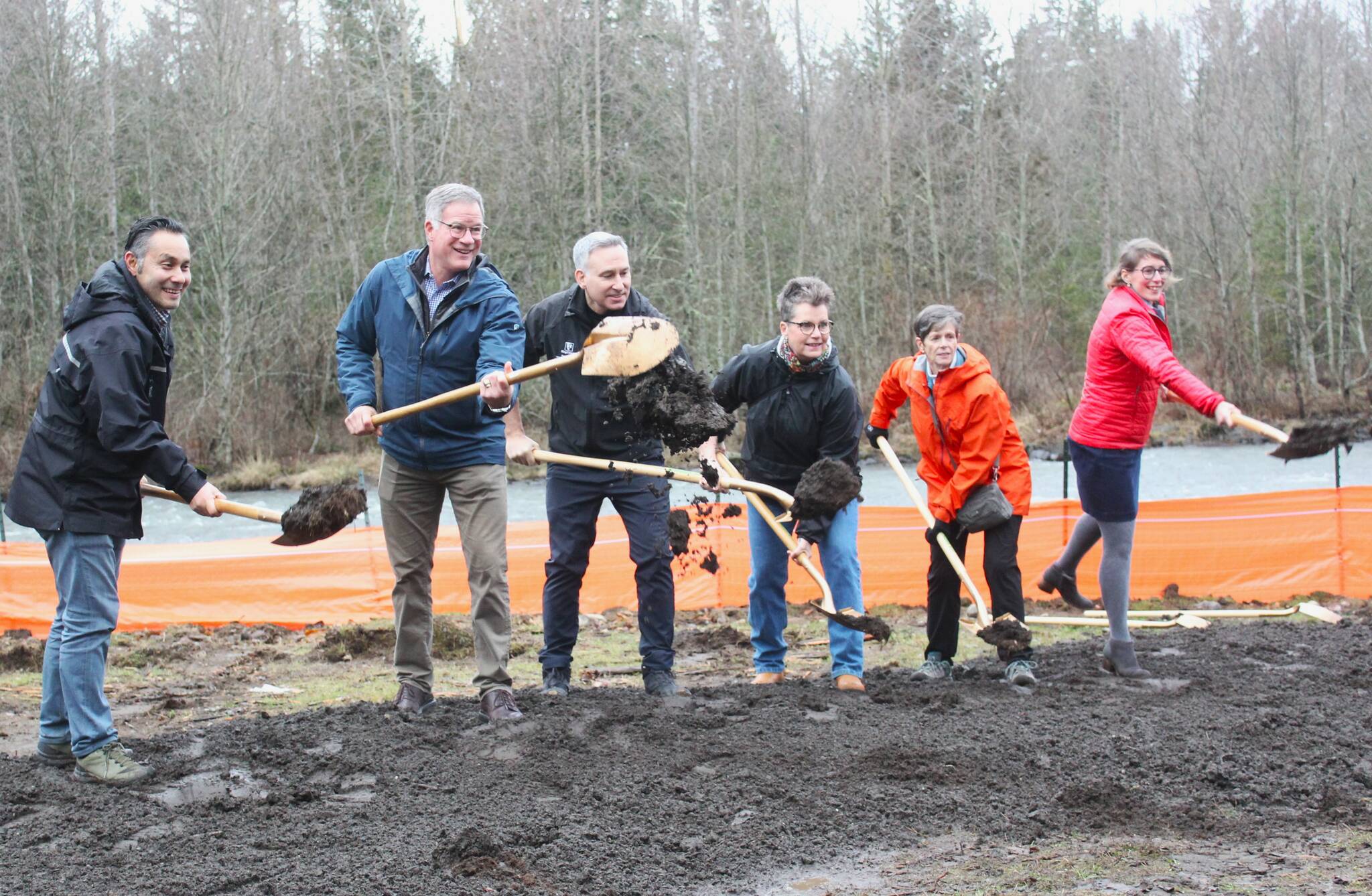 Jiminez, Dammeier, Constantine, Reynolds, Johnson, and Miles executing the ceremonial groundbreaking at the Foothills Trail bridge construction site on the Buckley side of the river. Photo by Ray Miller-Still