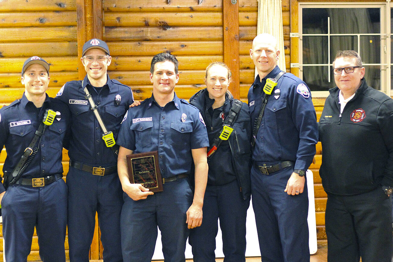 Firefighter Ryan Rodenberg (middle). Photo by Ray Miller-Still