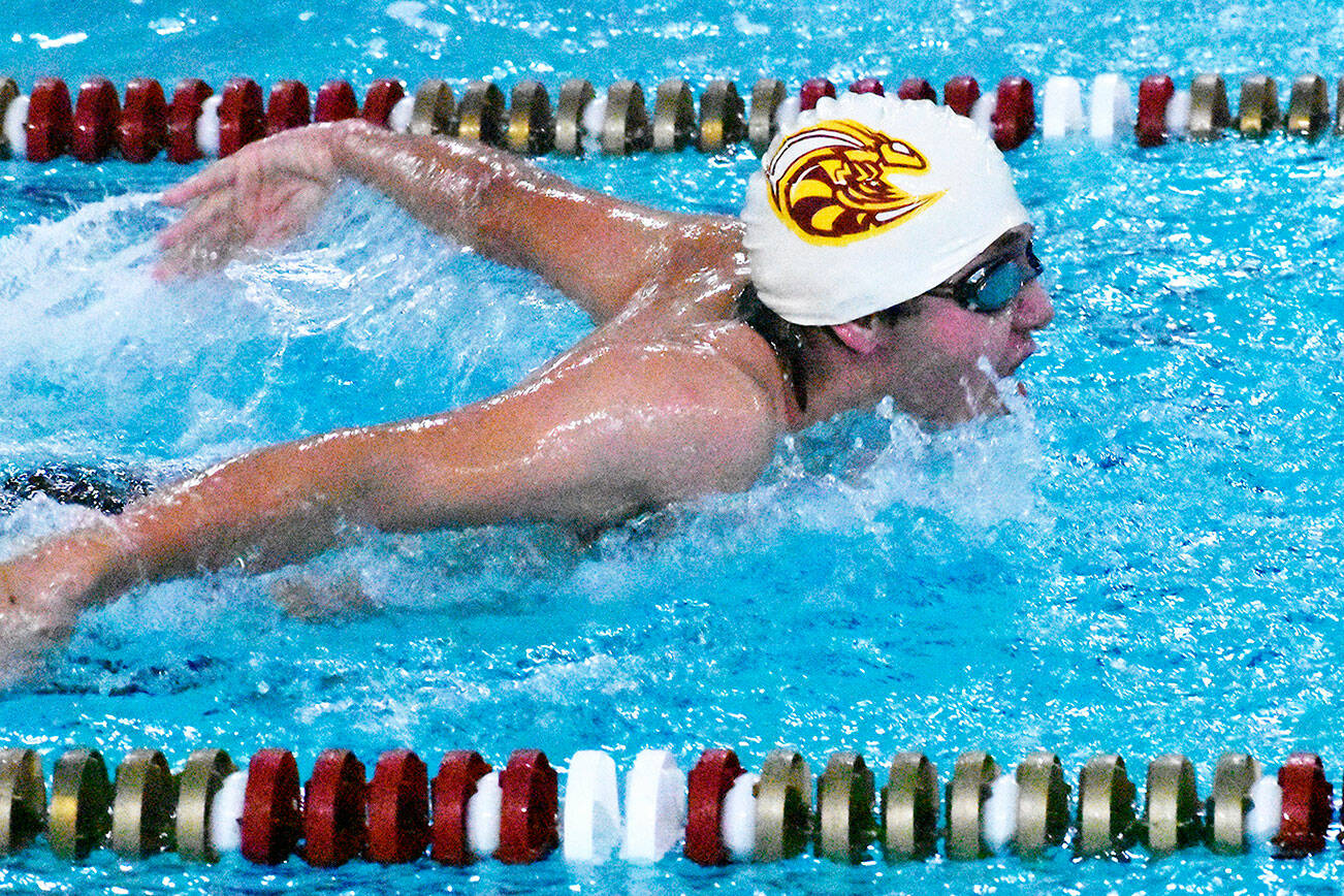 Swimmers from Enumclaw and White River high schools wrapped up the regular season Jan. 31 with a successful home meet against a combined Franklin Pierce/Washington squad. In this photo, Enumclaws Rishi Burt (white cap) competes in the butterfly leg of the medley relay. Photo by Kevin Hanson
