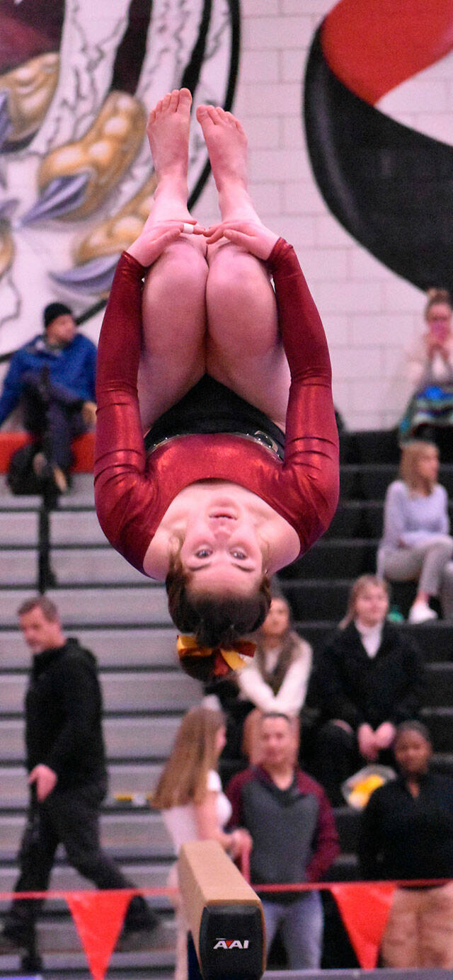 Enumclaw’s Ashley Dickerson, midway through a backflip dismount from the balance beam. Photo by Kevin Hanson
