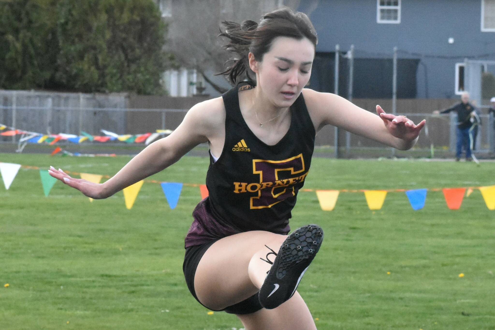 After taking a brief hiatus for spring break, the Enumclaw High track and field crew returns to action with a road meet against the Orting Cardinals. Action gets under way at 3:30 p.m. Thursday at Cardinal Stadium. Among the regulars who represent EHS are Saiya Flaherty in the hurdles and Michael Poleski (left) and Jack Heise, both members of the boys’ relay squad. These photos came during the Hornets’ last home meet. Photos by Kevin Hanson/For the Courier-Herald
EHS’ Saiya Flaherty in the hurdles. Photo by Kevin Hanson/For the Courier-Herald
