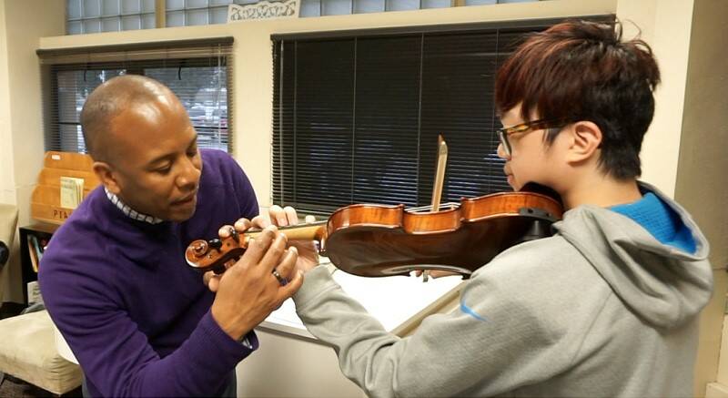 Dr. Quinton Morris helps a student during a lesson.