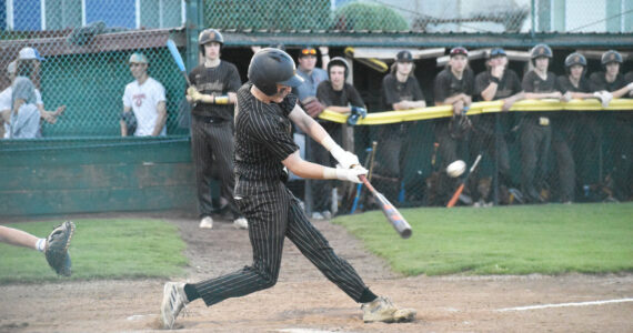 Photo by Kevin Hanson
The regular South Puget Sound League 2A season has wrapped up for most spring sports and postseason play awaits. Pictured here during a recent Enumclaw High School home baseball game is Casey Megargle putting a ball into play.