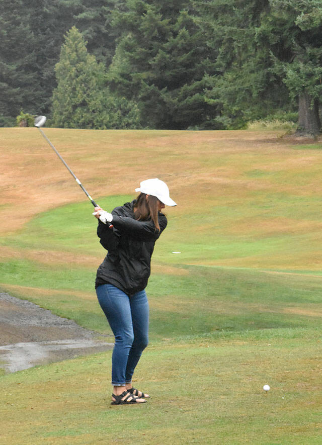 PHOTO BY KEVIN HANSON
The greens and fairways turned crimson and gray on a Saturday morning in 2021 when the Enumclaw Golf Course played host to a tournament that raised money for the WSU wrestling program. In this photo, Heather McCann begins with a drive down the first fairway.