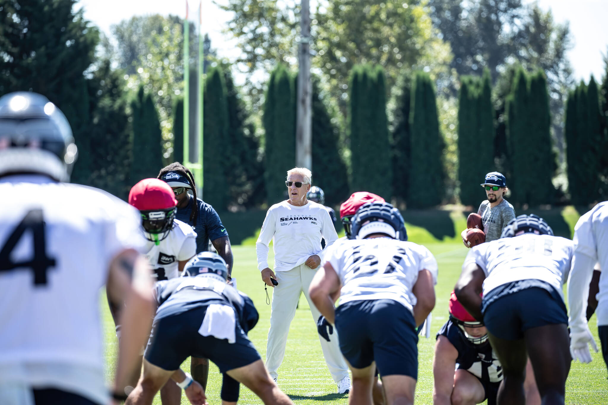Pete Carroll looks over the punt team at the beginning of practice. (Maria Dorsten Photography)