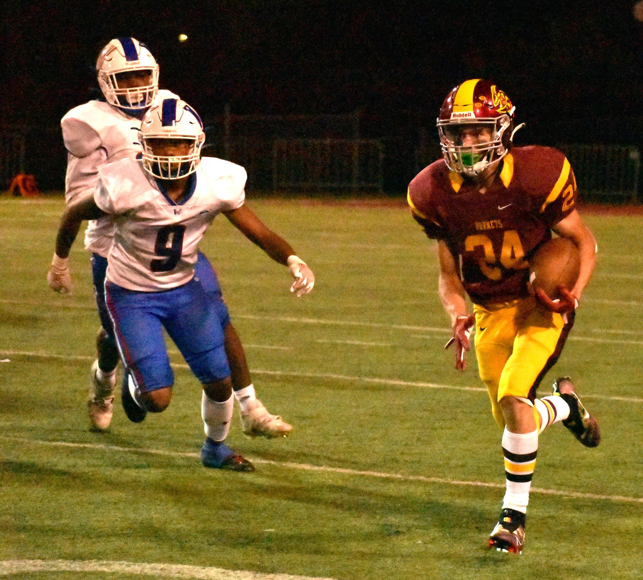 FILE PHOTO BY KEVIN HANSON 
The Enumclaw Hornets, who return many key pieces from a hugely successful 2022 squad, will kick off a new season Thursday night on their home turf. Among the varsity returnees is Louis Chevalier; in this photo from last fall, he gains yardage during a victory over Clover Park.