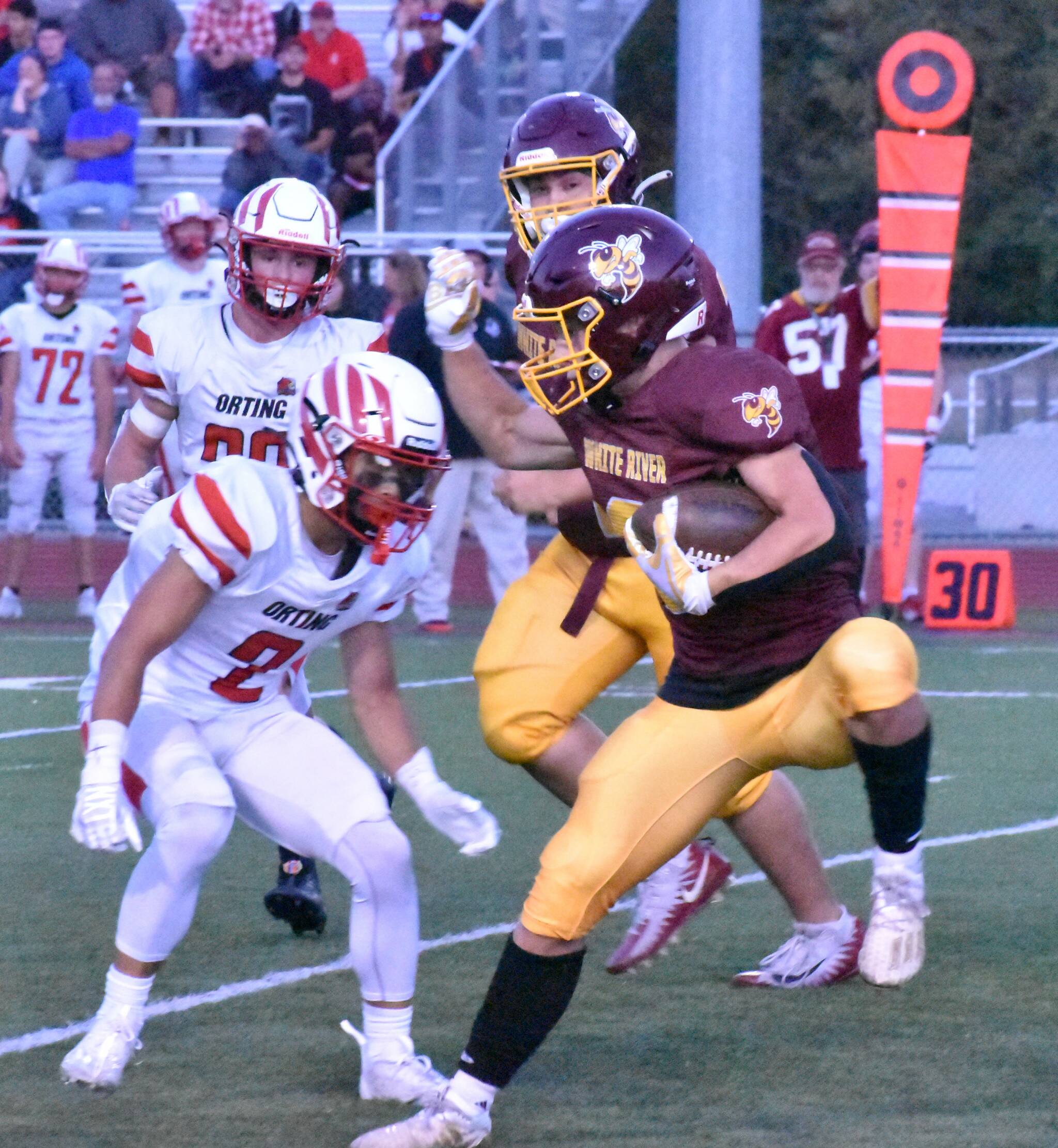 During White River’s Thursday home game, Hornet running back Tate Bowen attempts to elude a Cardinal defender. (Photo by Kevin Hanson)
