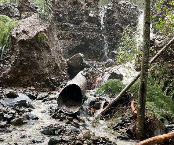 A debris flow this past November along Dry Creek overwhelmed a 24-inch culvert under SR 410 near Crystal Mountain Resort, causing water and about two feet of debris to cover the highway. It also caused scouring along the shoulder and embankment. Image courtesy Washington State Department of Transportation