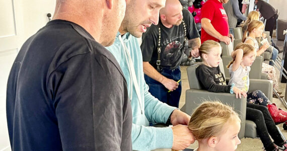 A group of fathers and their daughters at Salon Kathleen during a Daddy/Daughter Date Night, where dads learn how to do their kids’ hair. The quarterly classes are led by stylist Matt Fugate. Photo courtesy Samantha McCleary/ Samantha McCleary Photo