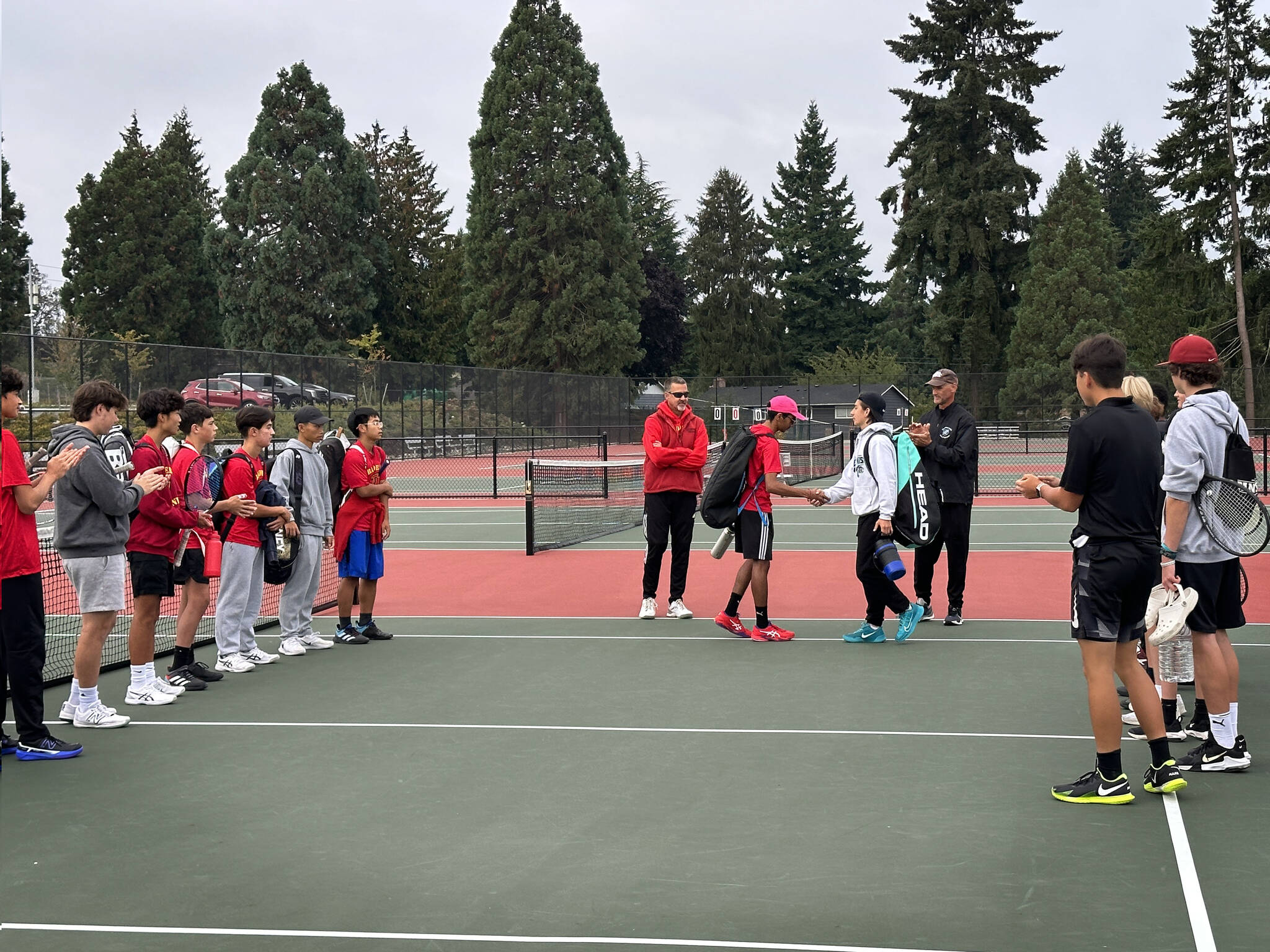 Gavin Orozco (Bonney Lake #1 Singles in white) shaking hands with Sanchit Sharma (Thomas Jefferson #1 Singles in red). Photo by Andy Orozco