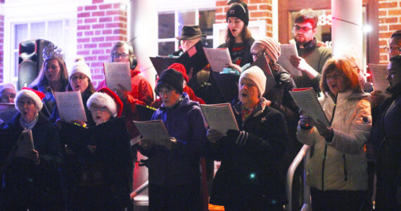 The city of Enumclaw held its annual tree lighting in front of City Hall late last November; here is a previously unpublished photo of a choir singing on the front steps of City Hall. Photo by Ray Miller-Still